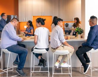 employees sitting at the kitchen bar