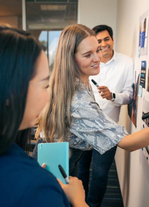 team reviewing creative work on the wall