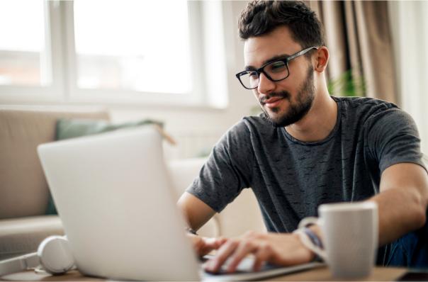 man looking at laptop smiling